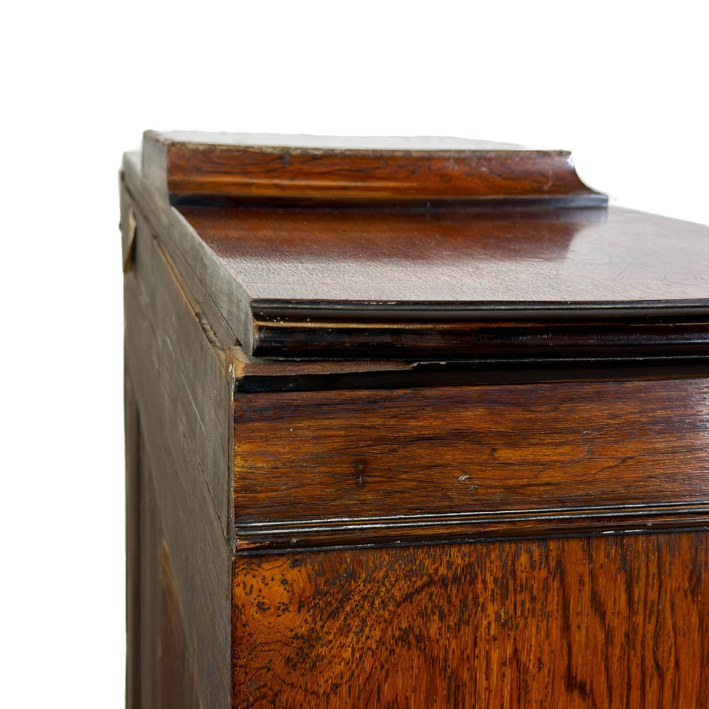 An Edwardian dark mahogany display cabinet featuring two glazed doors, satinwood scroll marquetry along the top frieze, and internal wooden shelves. View V