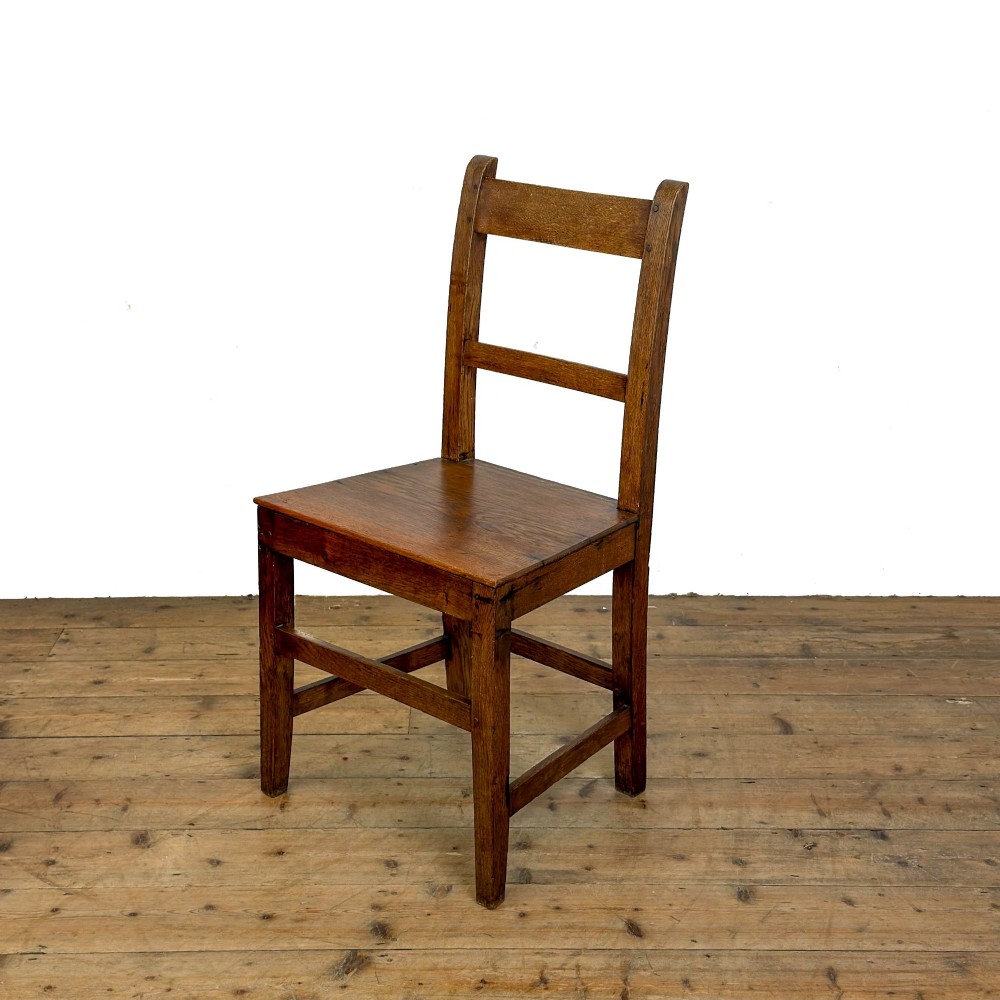 A harlequin set of four dark brown oak country dining chairs featuring horizontal ladder backs and solid wood seats on square legs. View II