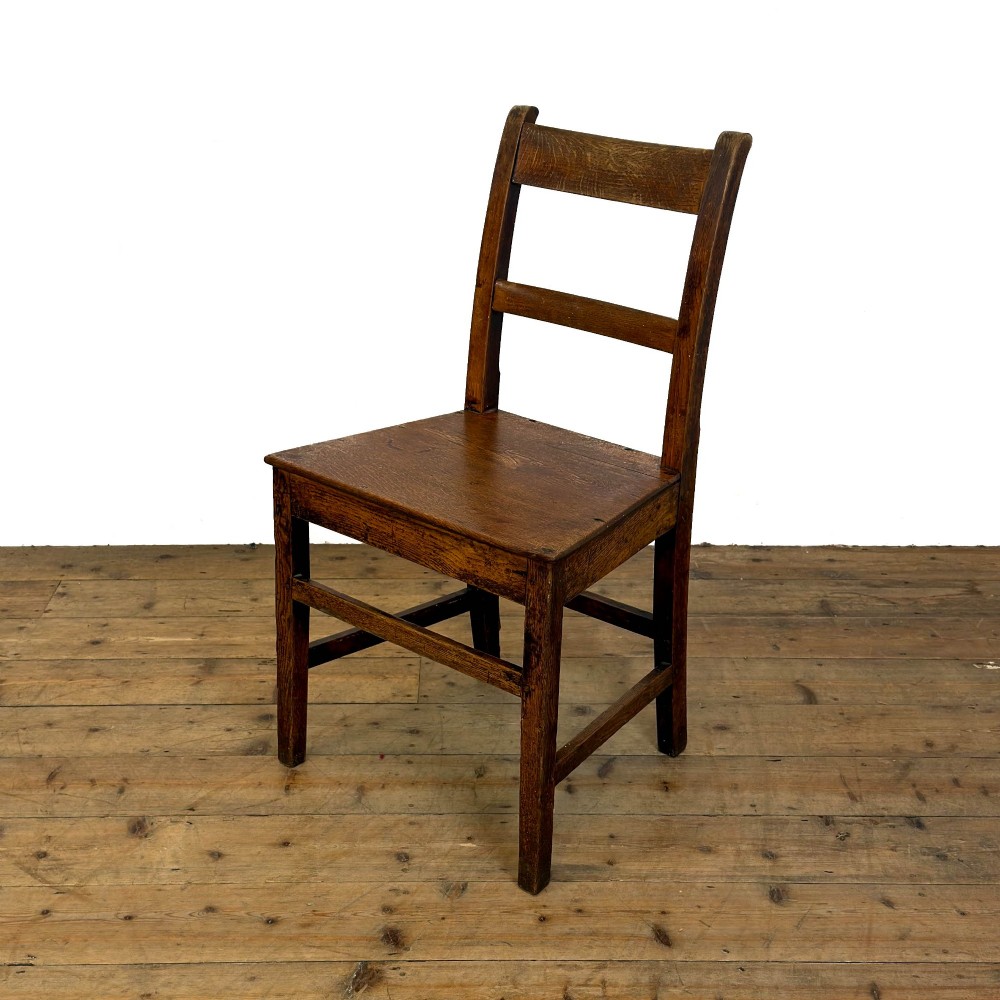 A harlequin set of four dark brown oak country dining chairs featuring horizontal ladder backs and solid wood seats on square legs. View VII