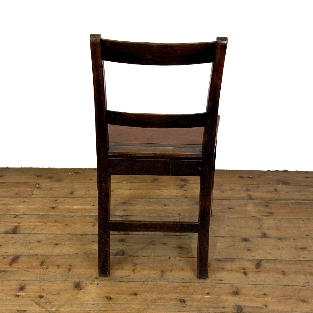 A harlequin set of four dark brown oak country dining chairs featuring horizontal ladder backs and solid wood seats on square legs. View VIII