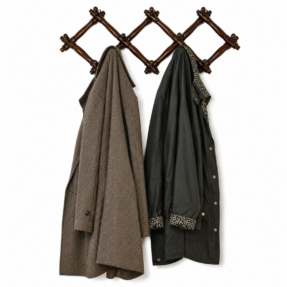A dark brown wooden extending accordion coat rack with turned pegs arranged in a diamond lattice frame.
