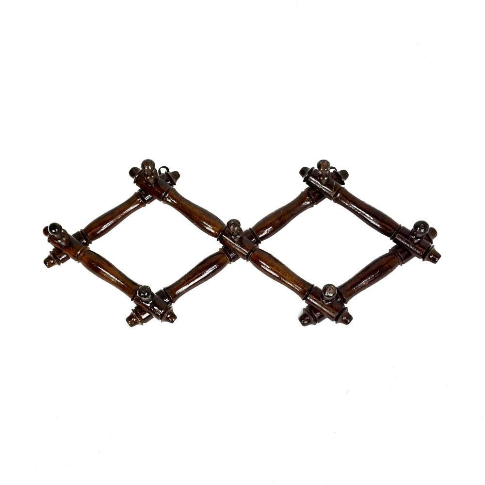A dark brown wooden extending accordion coat rack with turned pegs arranged in a diamond lattice frame. View III