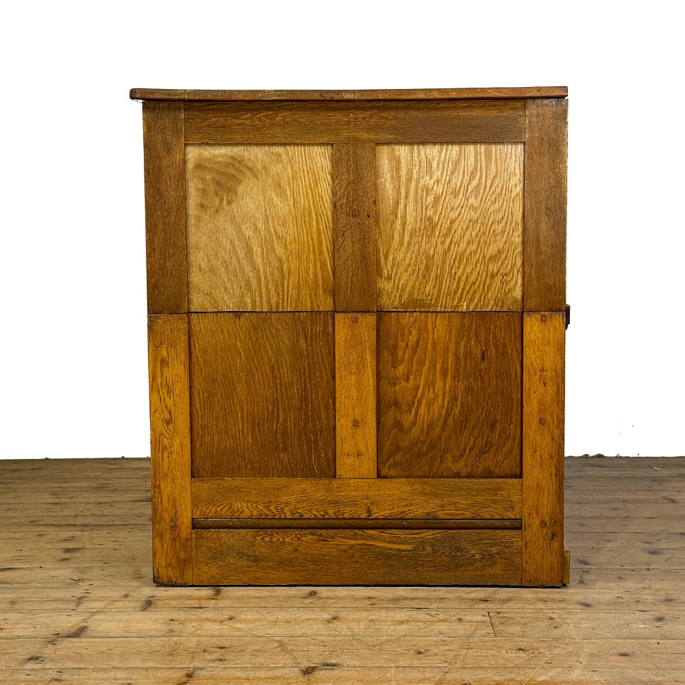 A vintage pale oak chest of drawers featuring four small top drawers above three wide drawers, fitted with dark metal cup handles. View IV