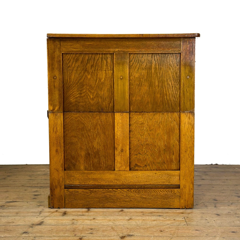 A vintage pale oak chest of drawers featuring four small top drawers above three wide drawers, fitted with dark metal cup handles. View VI