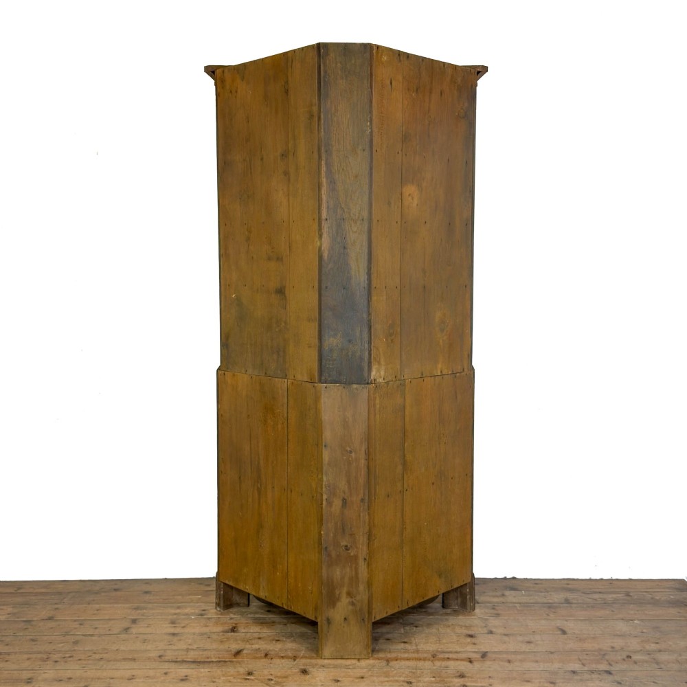 A two-tier freestanding Georgian oak corner cabinet with panelled double doors, brass keyhole escutcheons, and a moulded cornice. View V