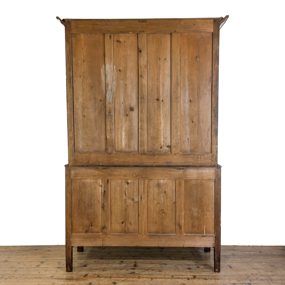 A 19th-century oak linen press featuring a two-door upper cupboard flanked by barley twist columns above a chest of drawers. View VIII