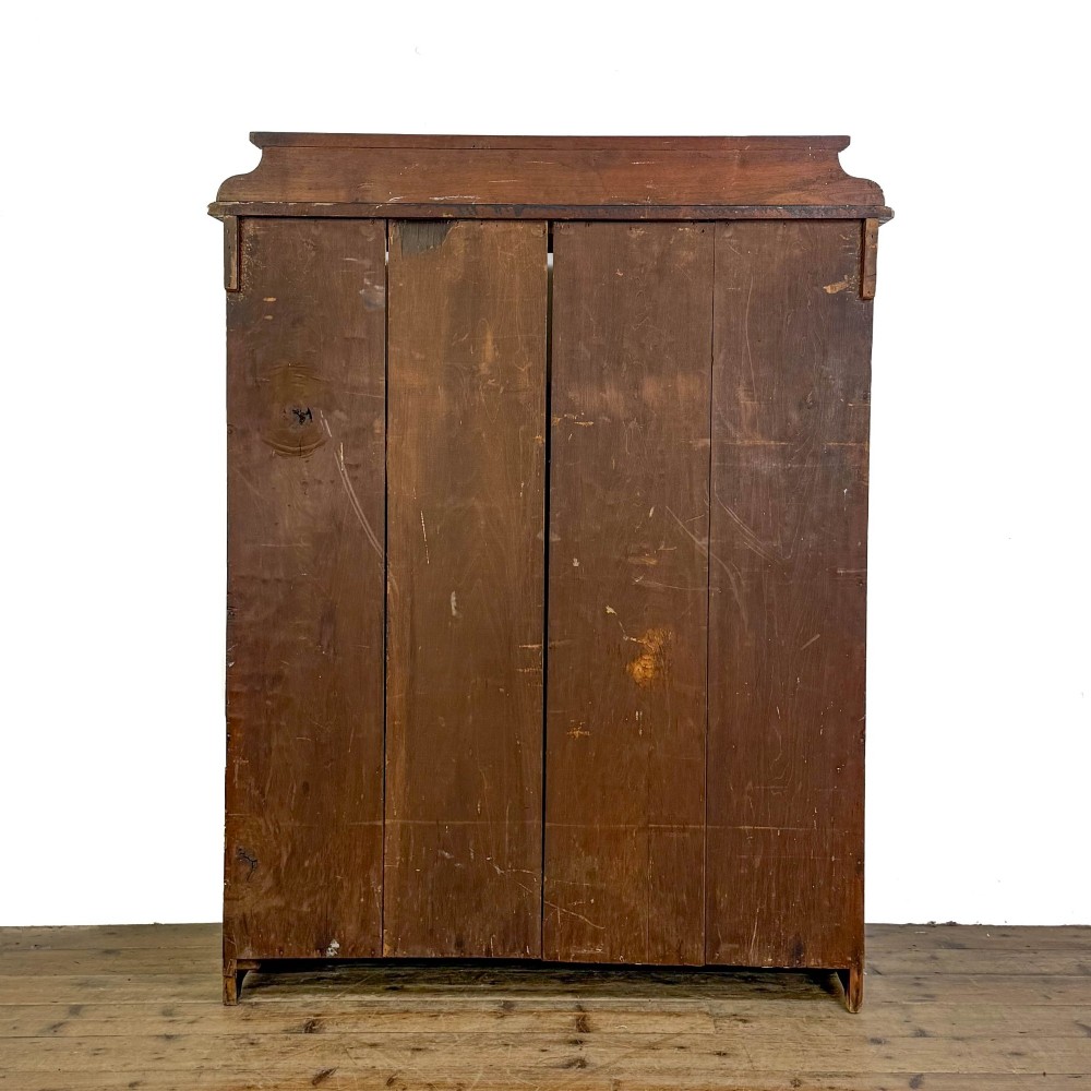 A tall 19th-century open wooden bookcase featuring five fixed shelves, fluted side stiles, a stepped pediment, and a shaped apron base. View VI