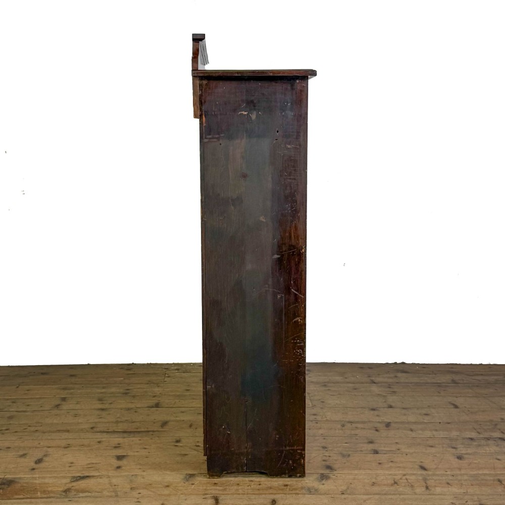 A tall 19th-century open wooden bookcase featuring five fixed shelves, fluted side stiles, a stepped pediment, and a shaped apron base. View VII