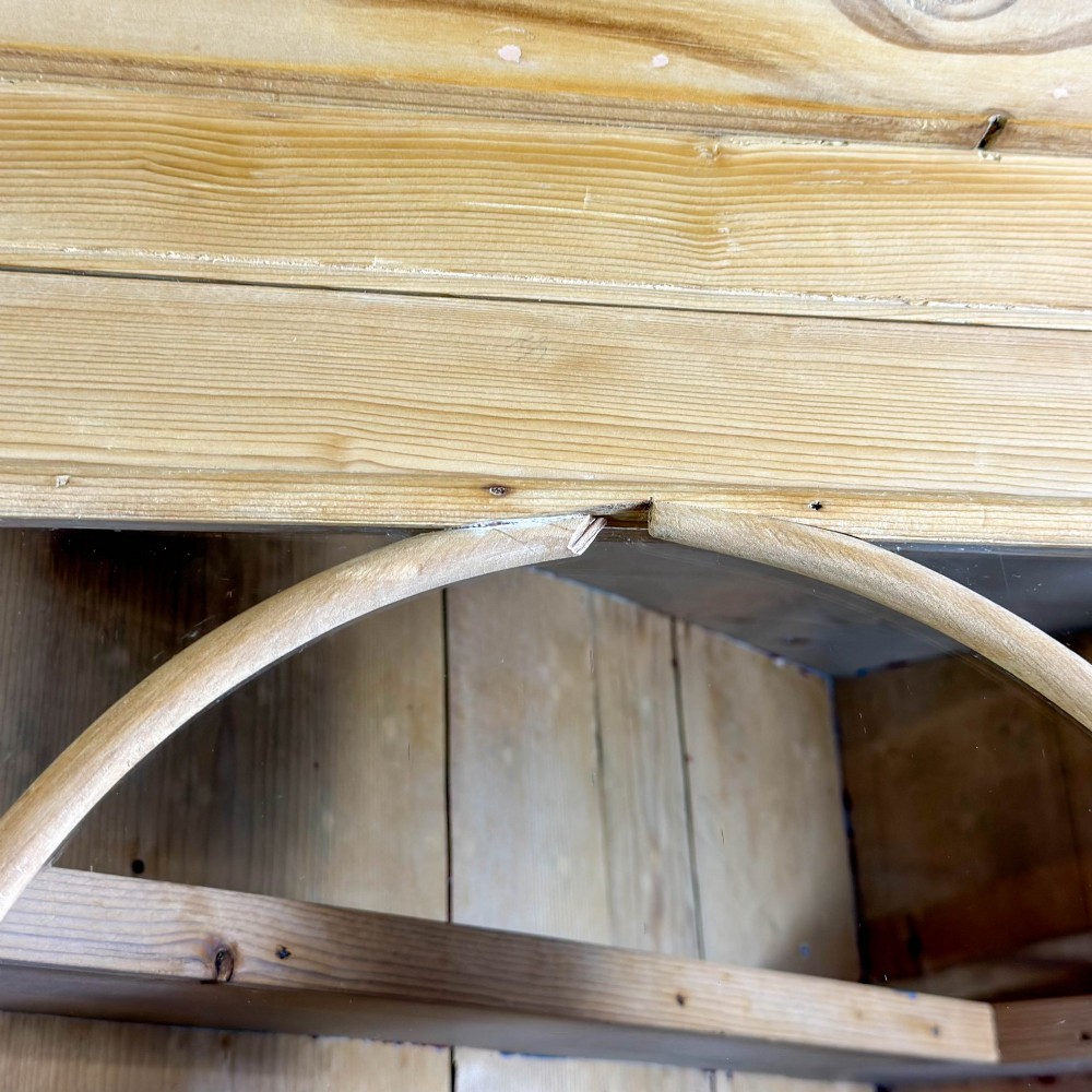 An antique stripped pine corner cabinet featuring arched glazed doors on the upper section, three drawers, and twin panelled cupboard doors below. View VII