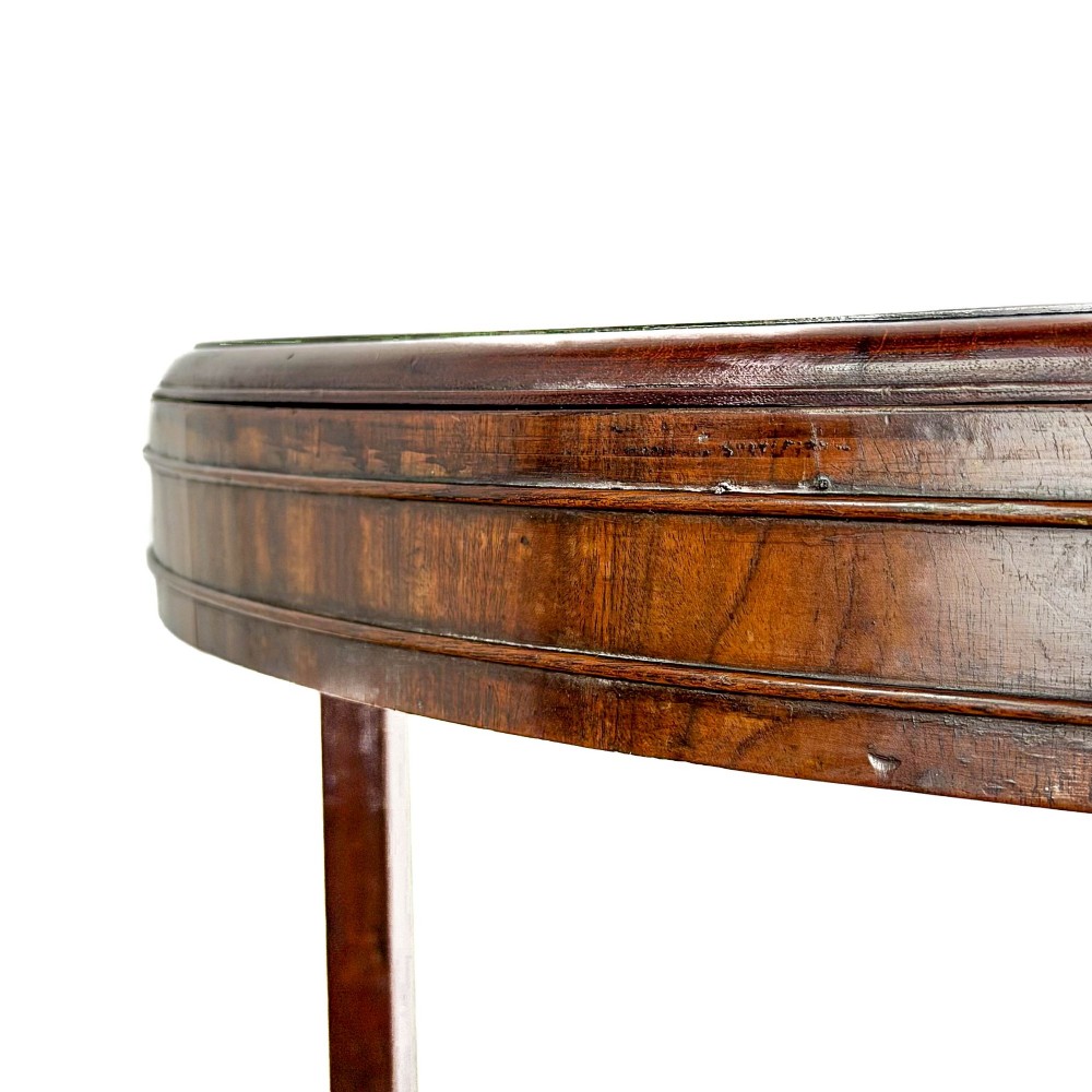 A Georgian dark mahogany triangular corner washstand featuring a smooth top shelf, a middle tier with three drawer fronts and brass ring handles, and slender legs connected by a lower stretcher. View IV