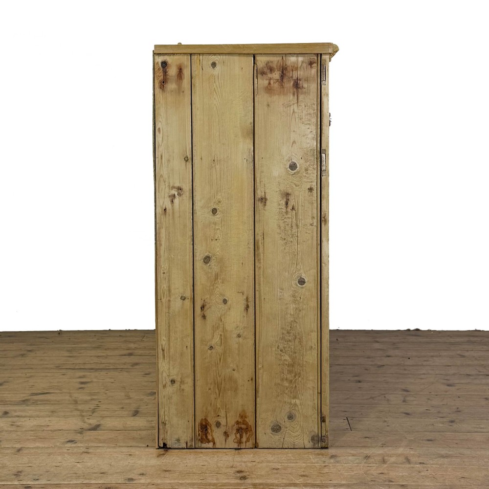A Victorian pine dresser base with three frieze drawers, ceramic drawer knobs, two panelled cupboard doors, and a central open shelving recess. View IX