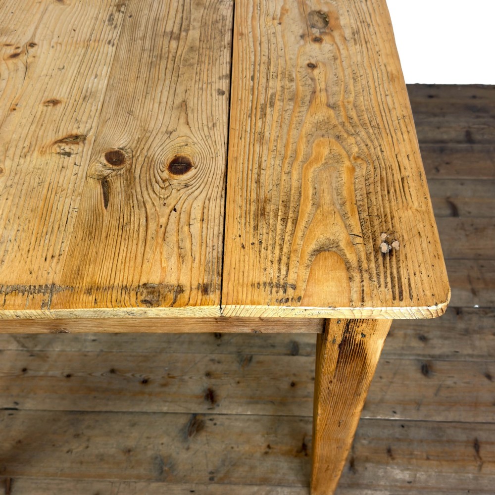 An antique pine kitchen table featuring a plank top, a single apron drawer with a cast iron cup handle, and four tapered square legs. View VIII