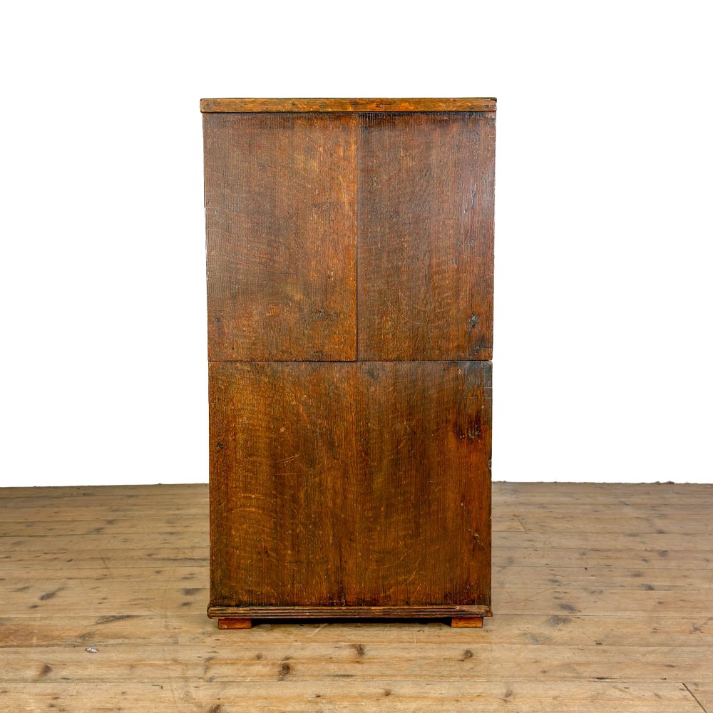 A nineteenth-century oak chest of drawers featuring two short over three long drawers with brass ring handles. View III