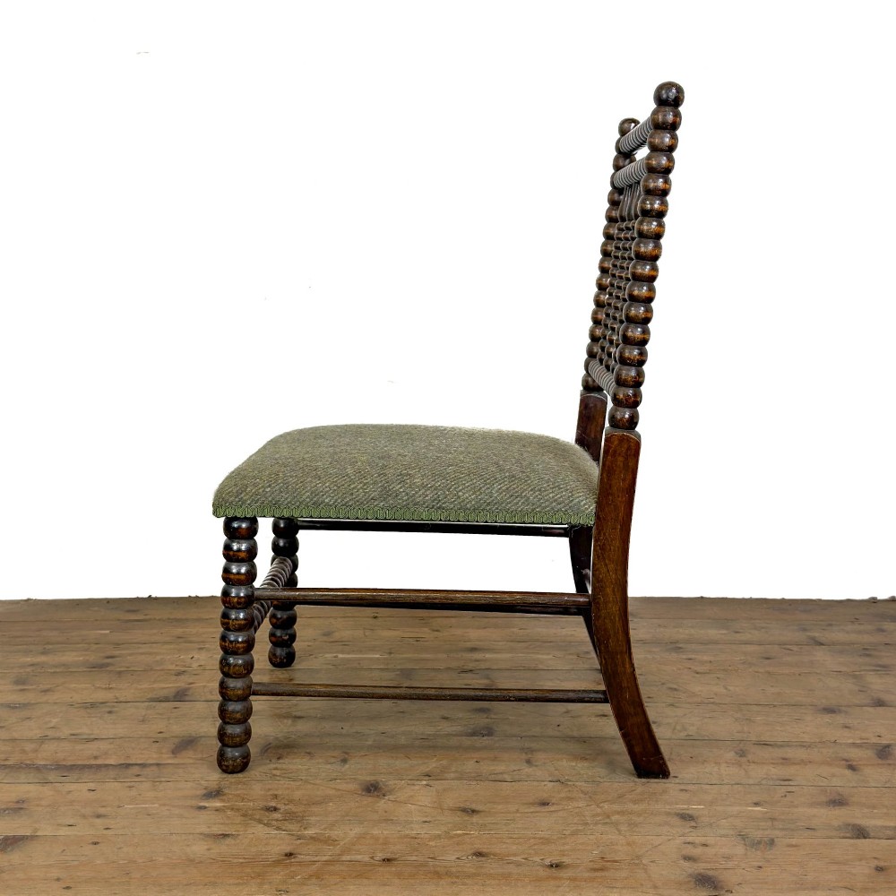 A Victorian bobbin-turned dark timber side chair featuring a textured green wool tweed upholstered seat. View III