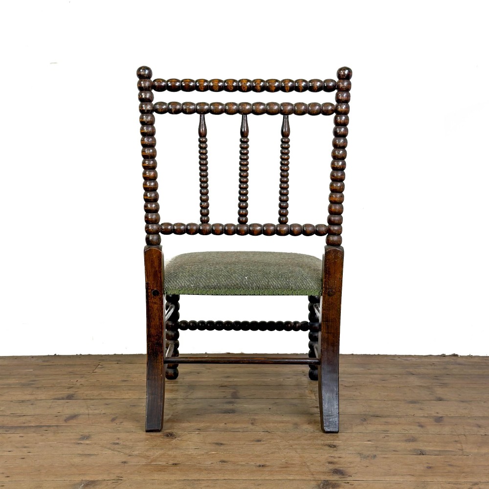 A Victorian bobbin-turned dark timber side chair featuring a textured green wool tweed upholstered seat. View IV