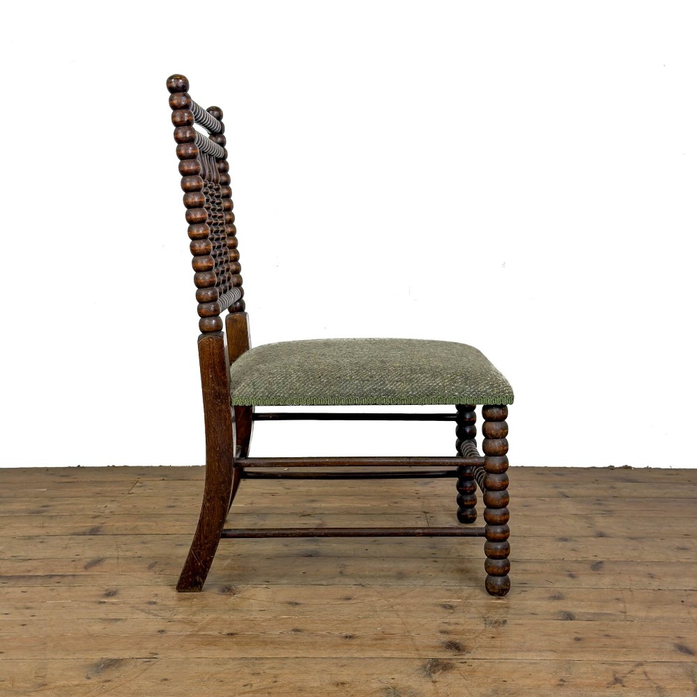 A Victorian bobbin-turned dark timber side chair featuring a textured green wool tweed upholstered seat. View V