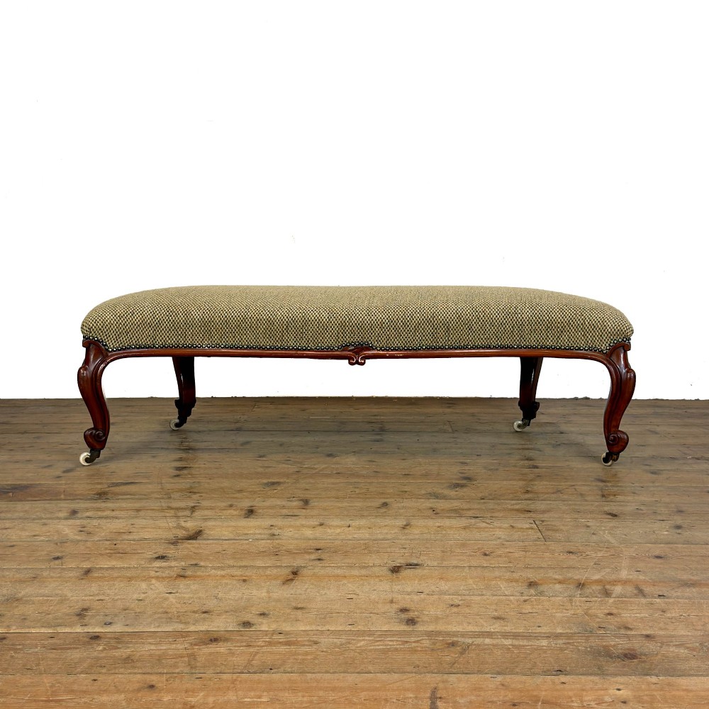 A long curved Victorian upholstered window seat featuring carved mahogany cabriole legs on castors and a patterned textile seat with studding detail. View II