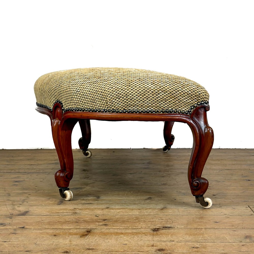 A long curved Victorian upholstered window seat featuring carved mahogany cabriole legs on castors and a patterned textile seat with studding detail. View VII