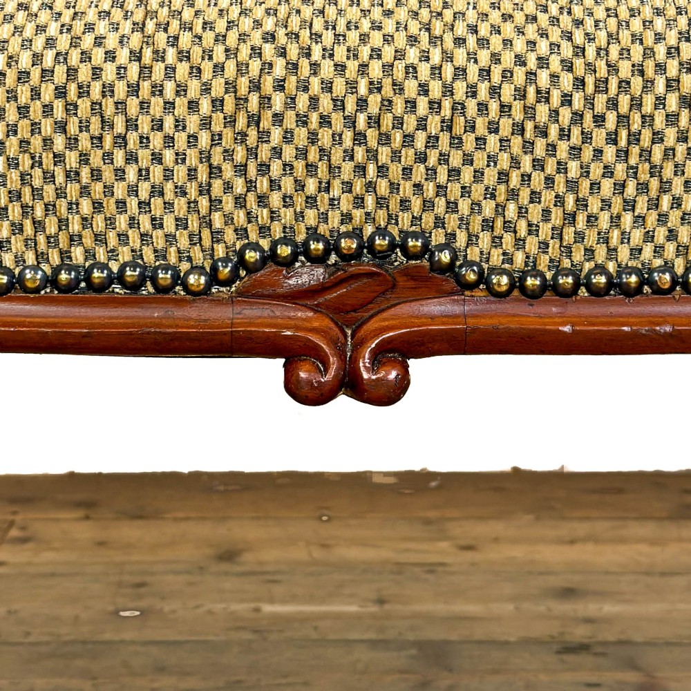 A long curved Victorian upholstered window seat featuring carved mahogany cabriole legs on castors and a patterned textile seat with studding detail. View VIII