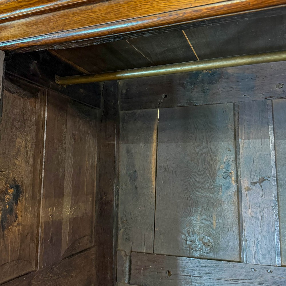 An eighteenth-century two-part Georgian oak livery cupboard with two multi-panelled doors above eight brass-handled drawers. View III