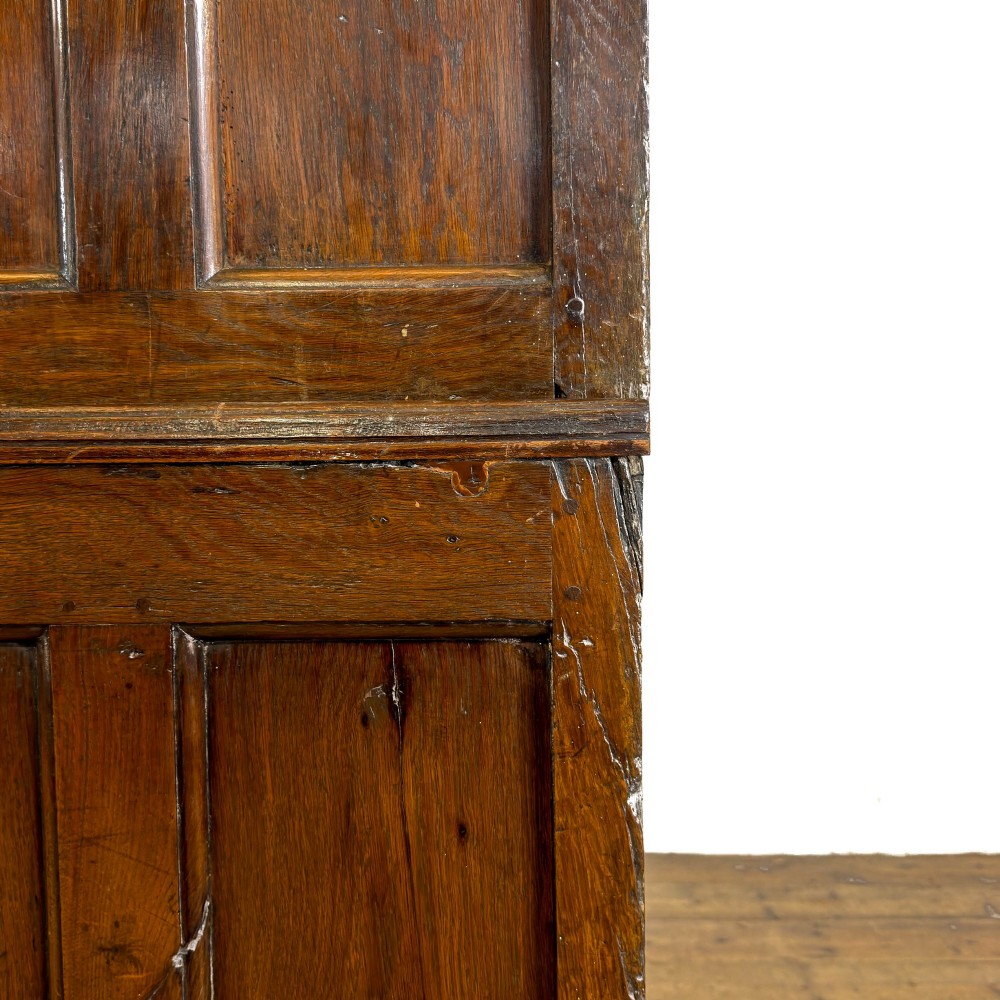 An eighteenth-century two-part Georgian oak livery cupboard with two multi-panelled doors above eight brass-handled drawers. View VII