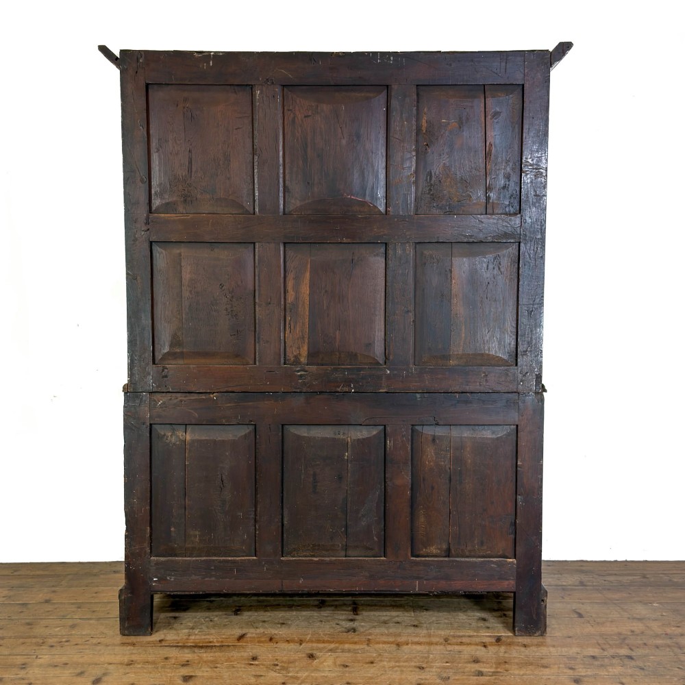 An eighteenth-century two-part Georgian oak livery cupboard with two multi-panelled doors above eight brass-handled drawers. View VIII