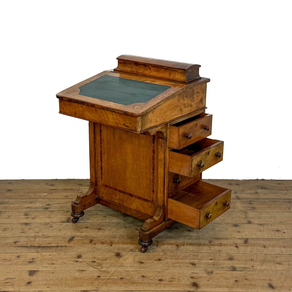 A Victorian burr walnut Davenport desk featuring a green leather writing slope, upper stationer compartment, side drawers, and brass castors. View II