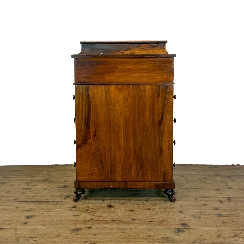 A Victorian burr walnut Davenport desk featuring a green leather writing slope, upper stationer compartment, side drawers, and brass castors. View XI