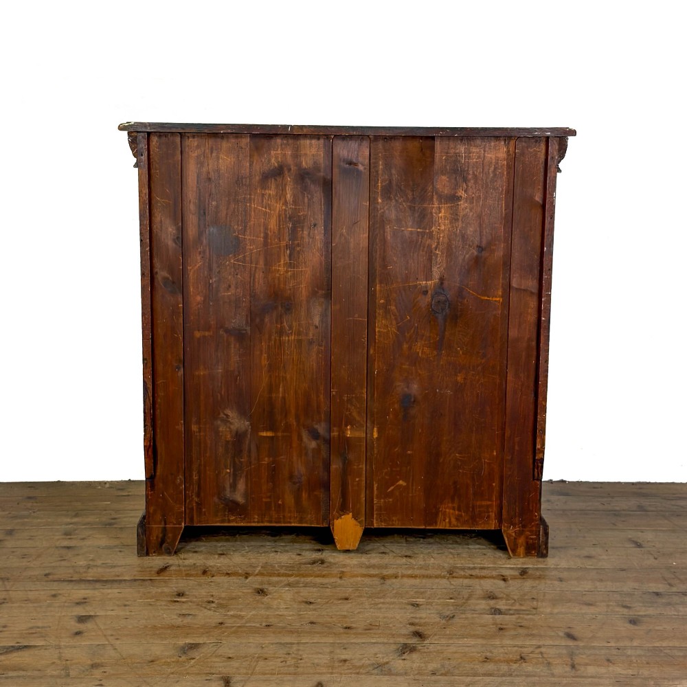 An antique dark oak open bookcase featuring hand-carved foliate detailing along the stiles and a carved upper frieze. View VI