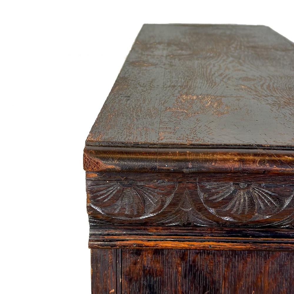 An antique dark oak open bookcase featuring hand-carved foliate detailing along the stiles and a carved upper frieze. View VIII