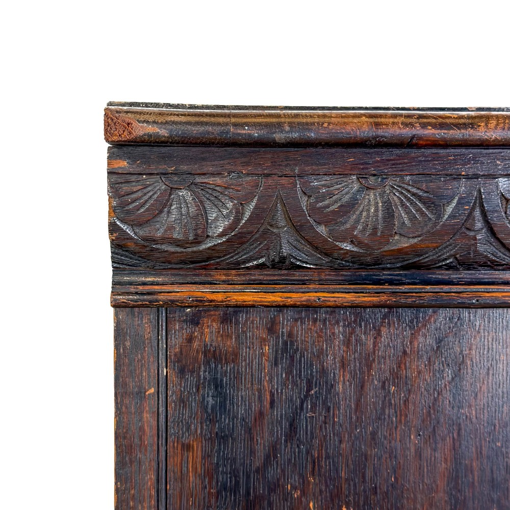 An antique dark oak open bookcase featuring hand-carved foliate detailing along the stiles and a carved upper frieze. View IX