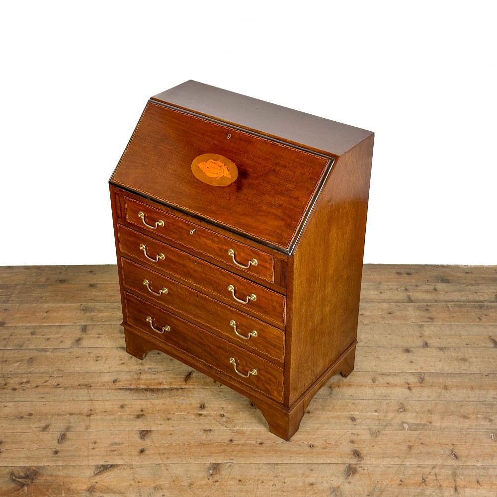 An antique Edwardian mahogany writing bureau featuring a sloping fall-front top with a shell marquetry inlay, situated above four graduating drawers with brass handles on bracket feet. View II