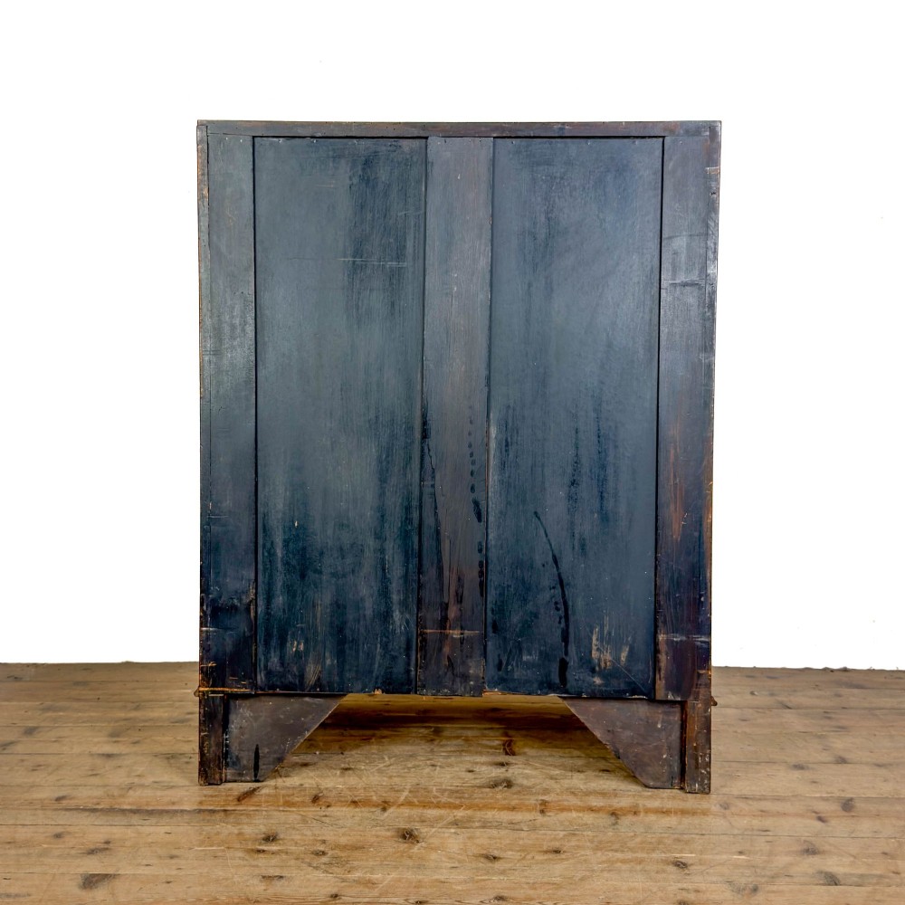 An antique Edwardian mahogany writing bureau featuring a sloping fall-front top with a shell marquetry inlay, situated above four graduating drawers with brass handles on bracket feet. View VII
