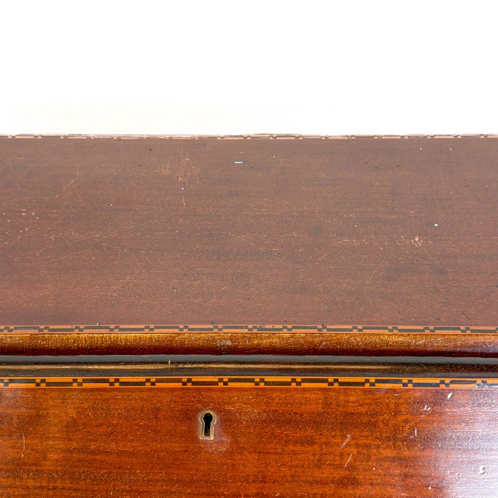 An antique Edwardian mahogany writing bureau featuring a sloping fall-front top with a shell marquetry inlay, situated above four graduating drawers with brass handles on bracket feet. View IX