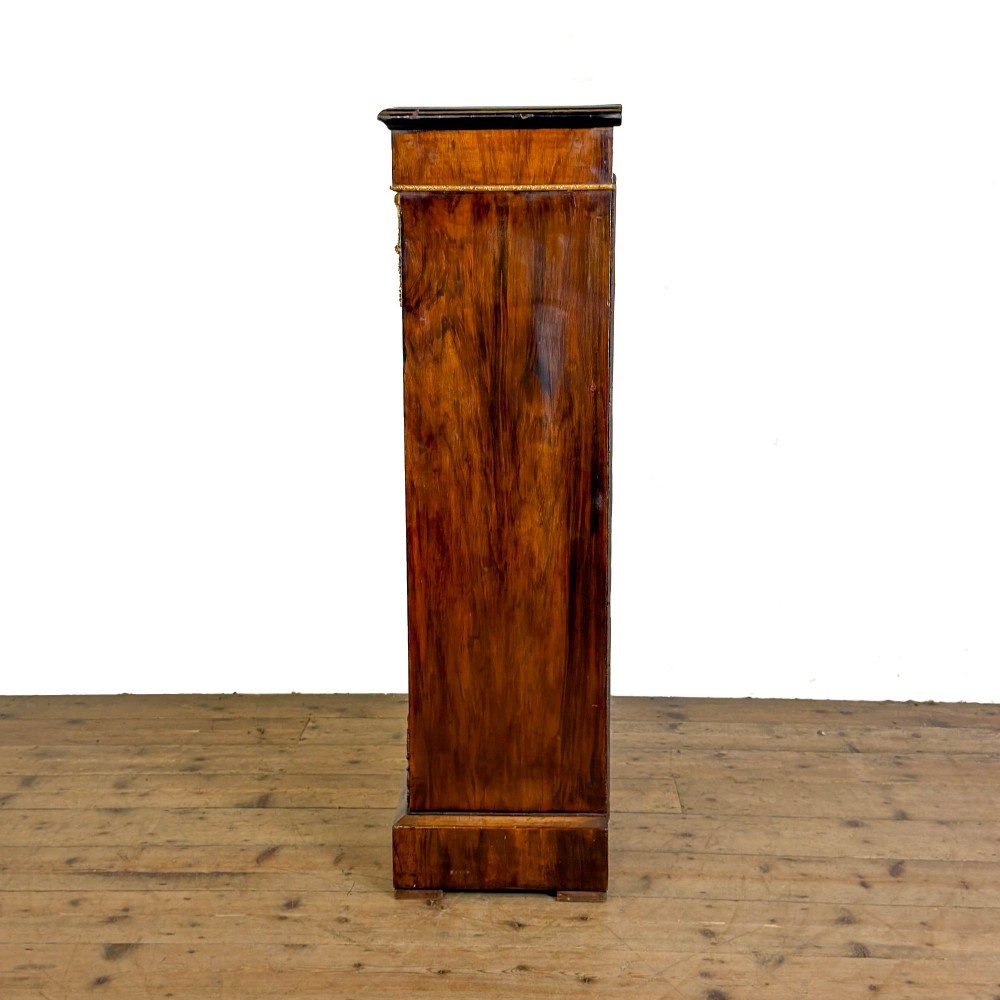 A Victorian inlaid walnut pier cabinet featuring a single glazed door, ormolu brass mounts, floral interior lining, and two interior shelves. View III