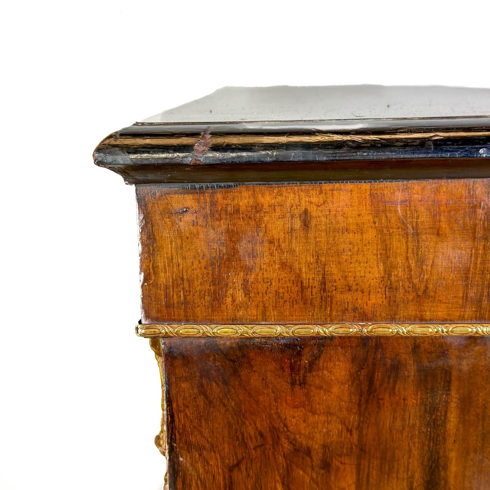 A Victorian inlaid walnut pier cabinet featuring a single glazed door, ormolu brass mounts, floral interior lining, and two interior shelves. View IX