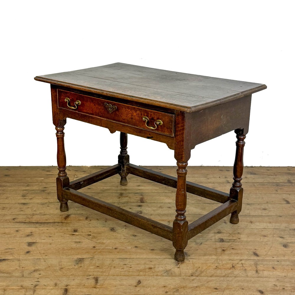 An 18th-century oak lowboy side table featuring a single drawer with brass drop handles, turned legs, and a lower box stretcher. View III