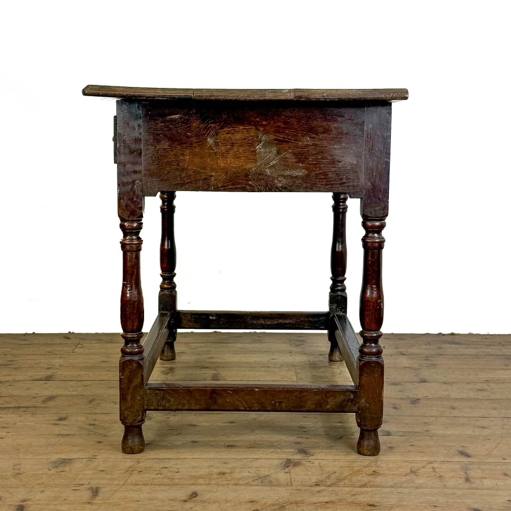 An 18th-century oak lowboy side table featuring a single drawer with brass drop handles, turned legs, and a lower box stretcher. View IV