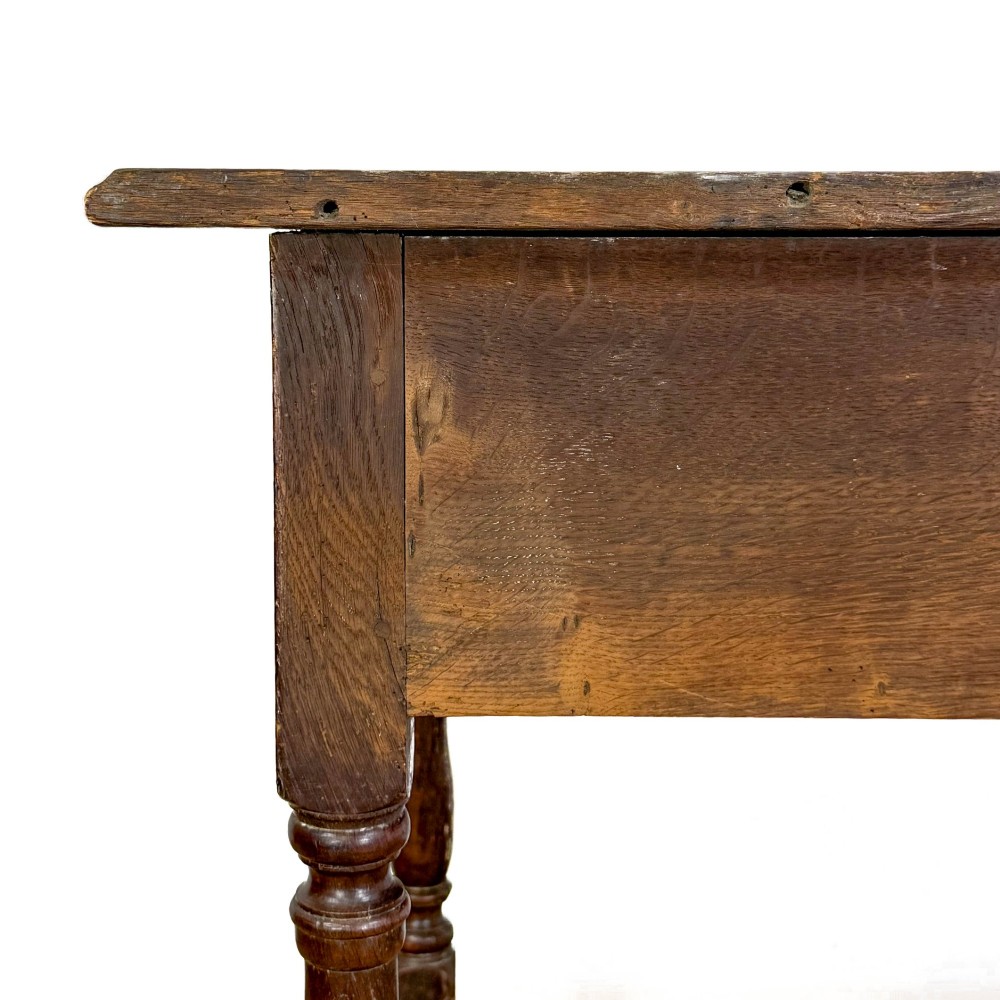An 18th-century oak lowboy side table featuring a single drawer with brass drop handles, turned legs, and a lower box stretcher. View VI
