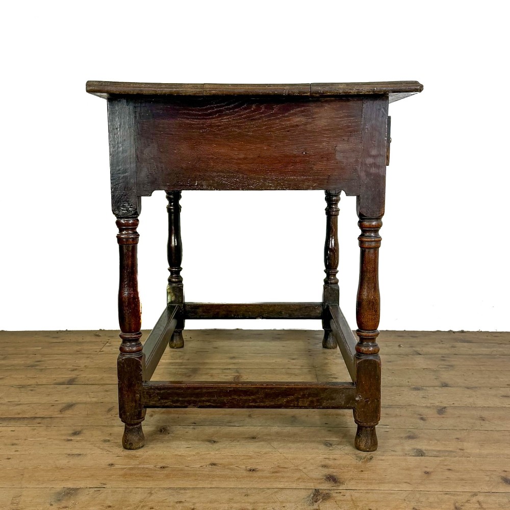 An 18th-century oak lowboy side table featuring a single drawer with brass drop handles, turned legs, and a lower box stretcher. View VII