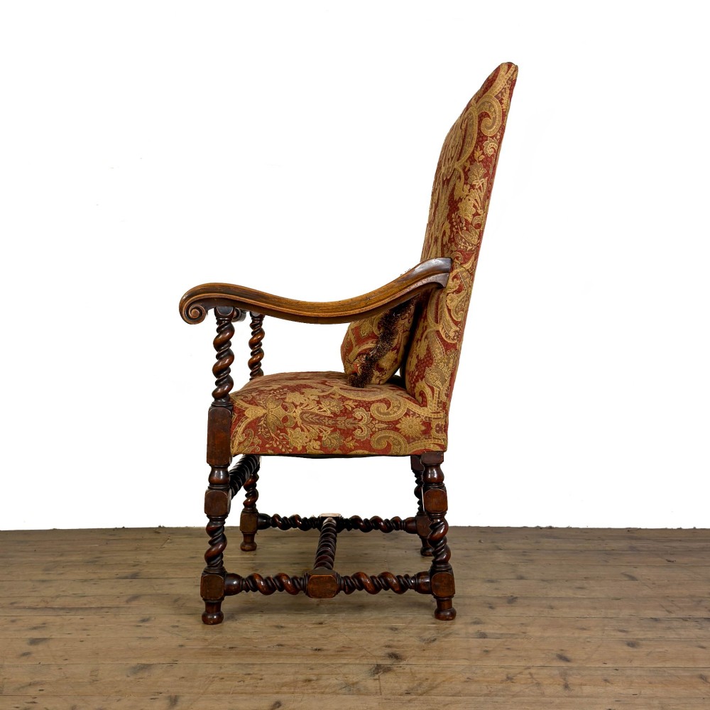 An antique walnut elbow chair featuring barley twist turnings, scrolled arms, and red and gold patterned upholstery with a matching cushion. View II
