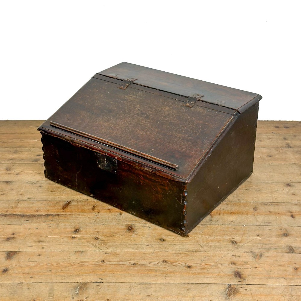 A dark brown oak bible box featuring a sloped hinged lid with a wooden rest ledge and an iron lockplate. View II