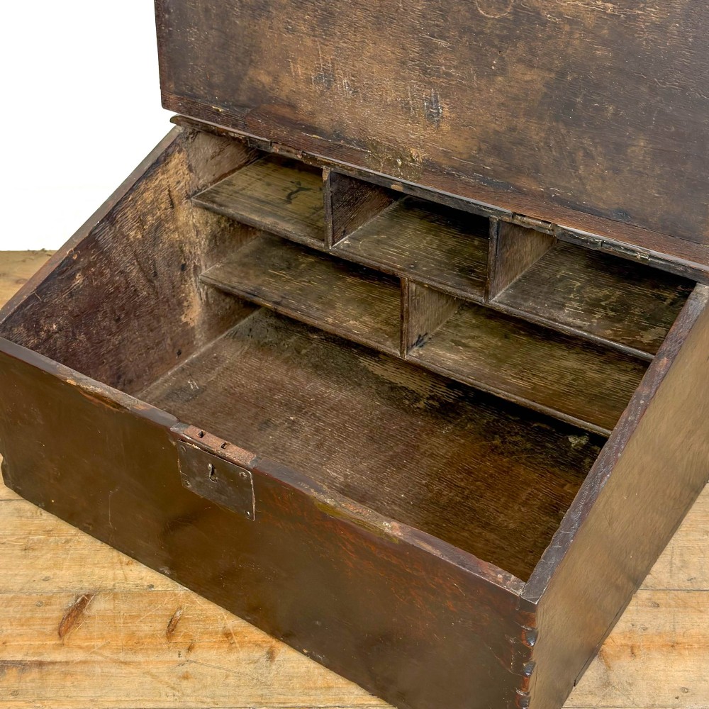 A dark brown oak bible box featuring a sloped hinged lid with a wooden rest ledge and an iron lockplate. View VI