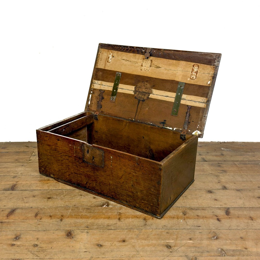 An 18th-century dark oak bible box featuring a hinged top lid, carved initials flanking a central iron lock plate, and a rectangular timber body. View X