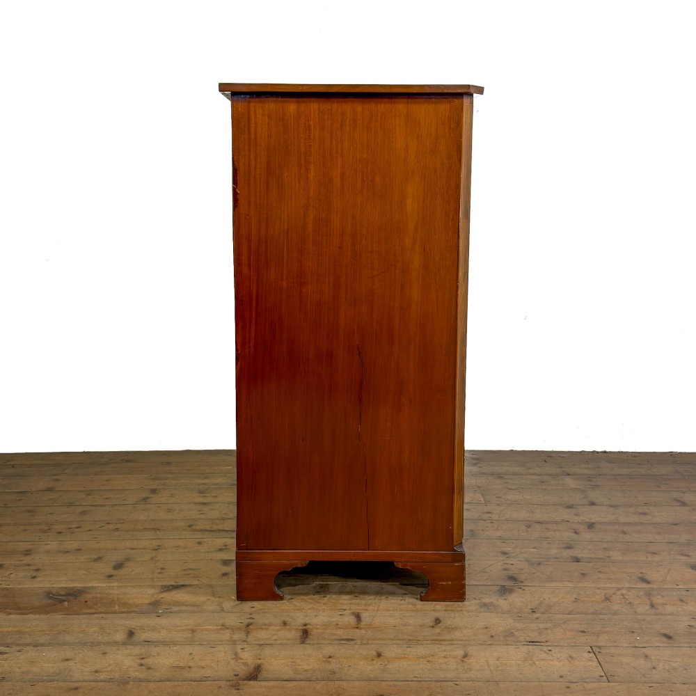 An antique mahogany serpentine chest featuring five graduated drawers with brass swan-neck handles and crossbanded inlay. View V
