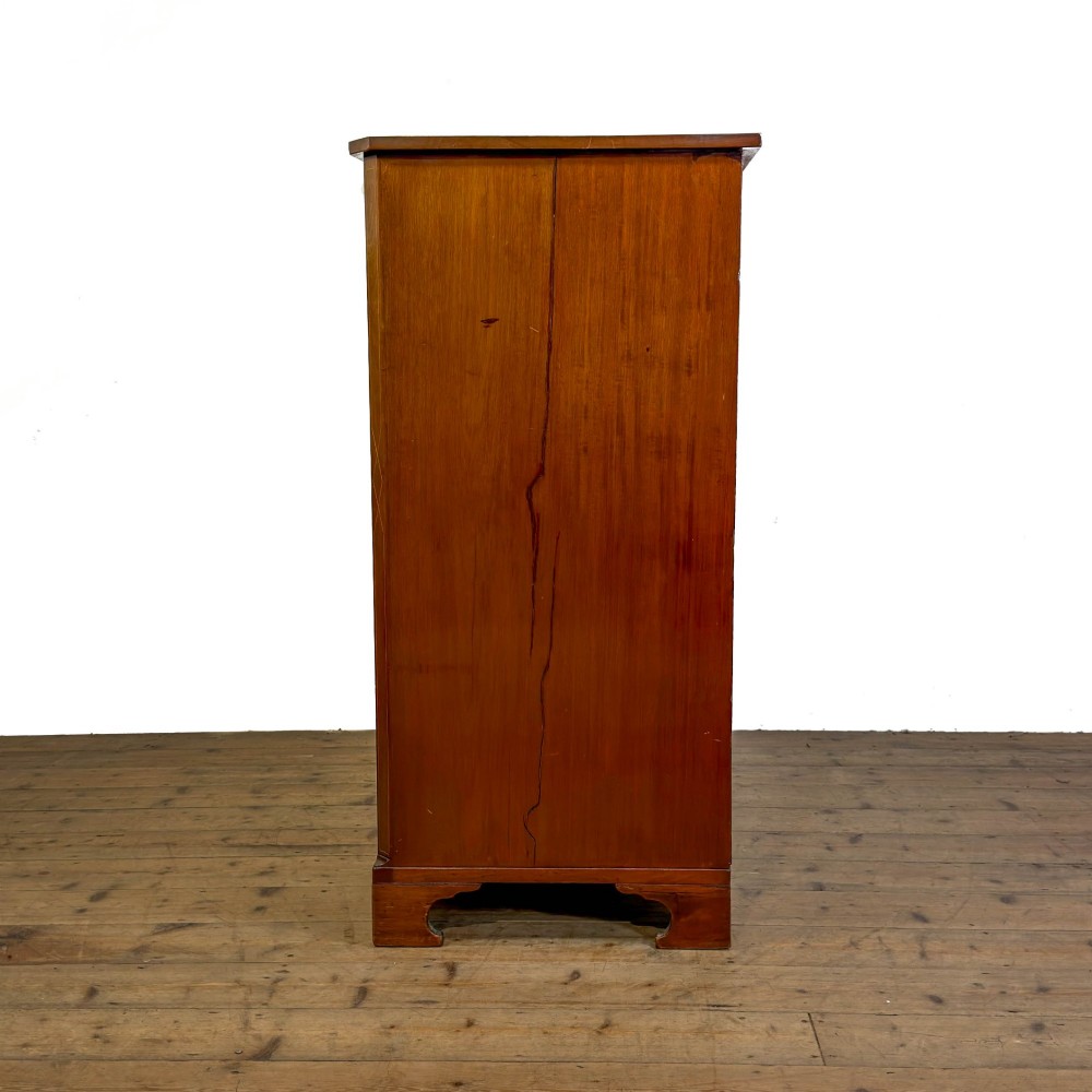 An antique mahogany serpentine chest featuring five graduated drawers with brass swan-neck handles and crossbanded inlay. View VIII