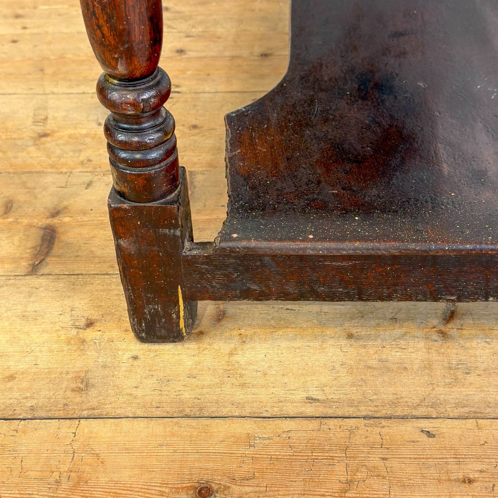 An antique dark wood dresser base featuring turned front legs, a scalloped apron, multiple drawers with wooden knob handles, and a lower pot board shelf. View IX