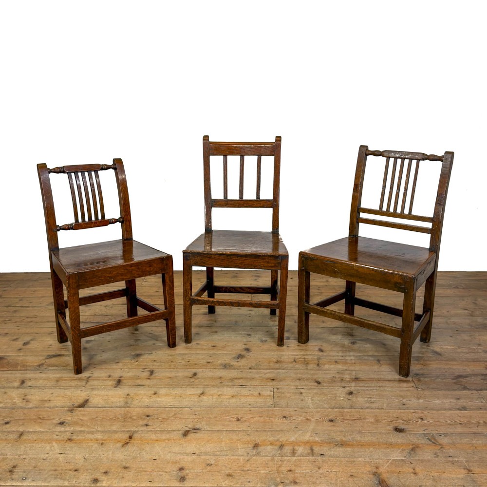 A set of three dark oak farmhouse dining chairs featuring vertical slat backs, solid wooden seats, and sturdy square stretchers. View II