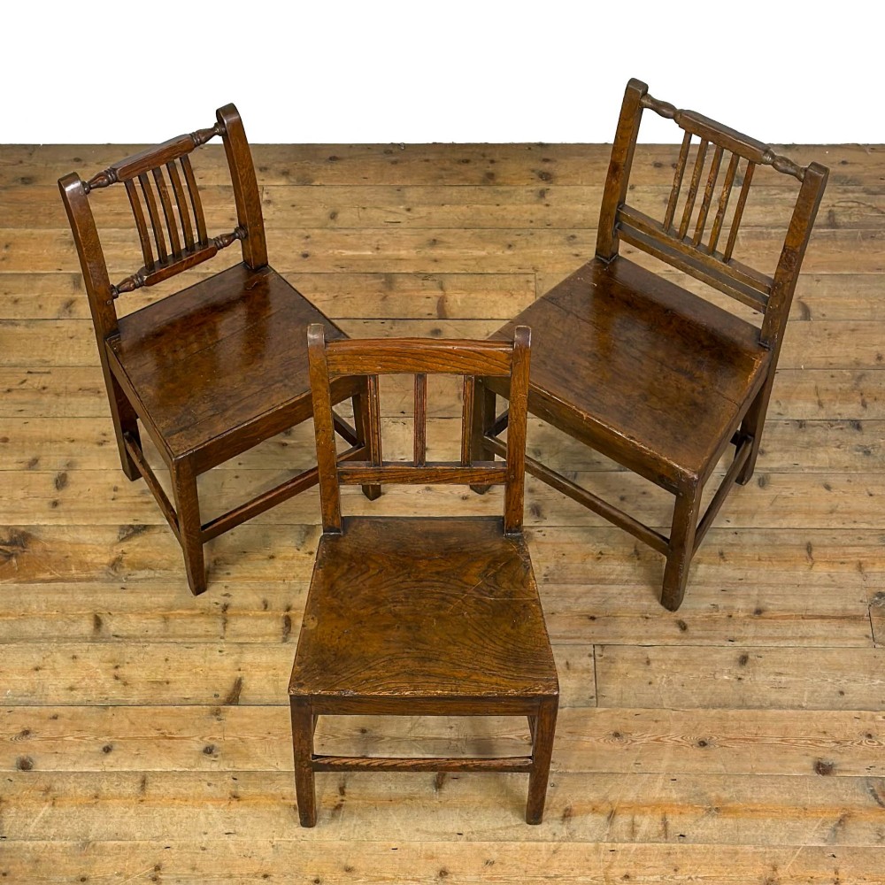A set of three dark oak farmhouse dining chairs featuring vertical slat backs, solid wooden seats, and sturdy square stretchers. View III