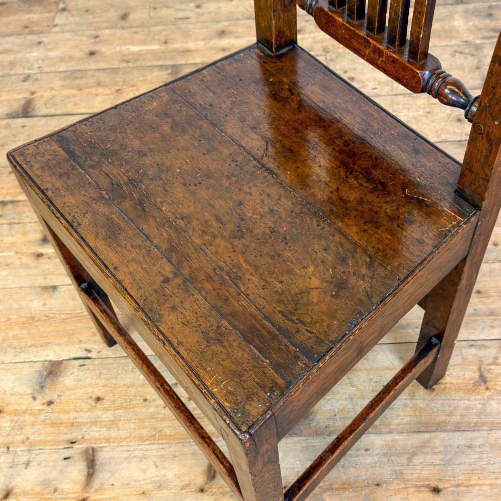 A set of three dark oak farmhouse dining chairs featuring vertical slat backs, solid wooden seats, and sturdy square stretchers. View V